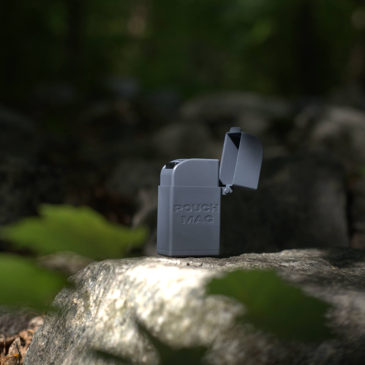 Pouch Mag Stone pouch dispenser on rock